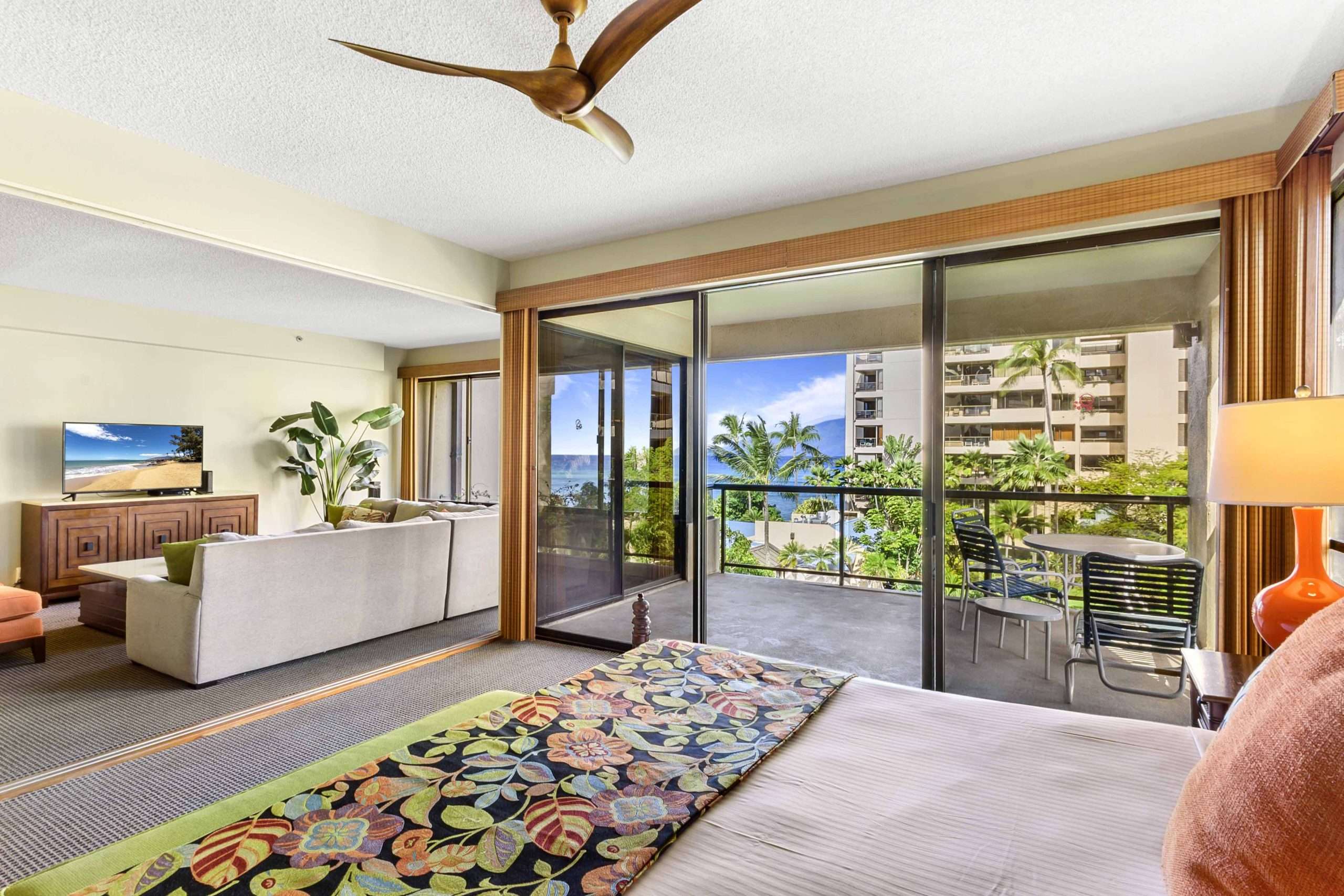 Three-bedroom family suite in Maui hotel with king bed, living area, and ocean-view balcony.