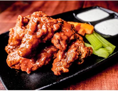 Buffalo wings with celery and carrot sticks, plus ranch dipping sauce at Captain Jack’s Island Grill in Maui.