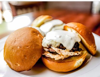 Three mini cheeseburgers on brioche buns with melted cheese at Captain Jack’s Island Grill in Maui.