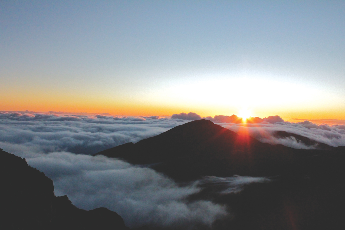 Sunrise above the cloud-covered Haleakalā crater—one of the top things to do in Maui.